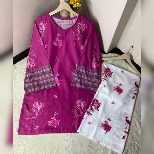 Purple and white embroidered shirts on hangers against a neutral wall.