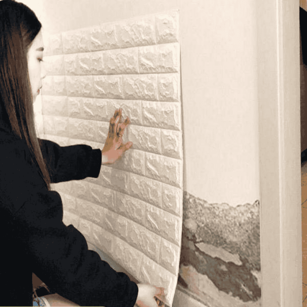 Side view of installing 3D brick wall sticker on a surface