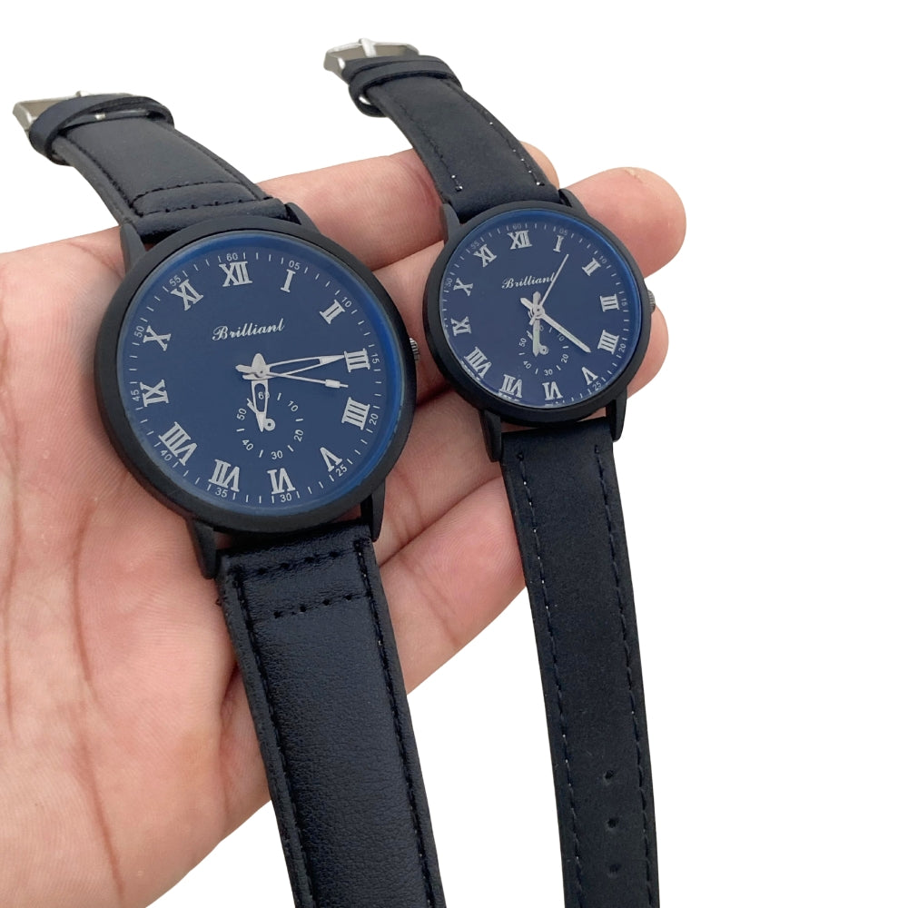 Two black wristwatches with blue faces held in a hand against a white background