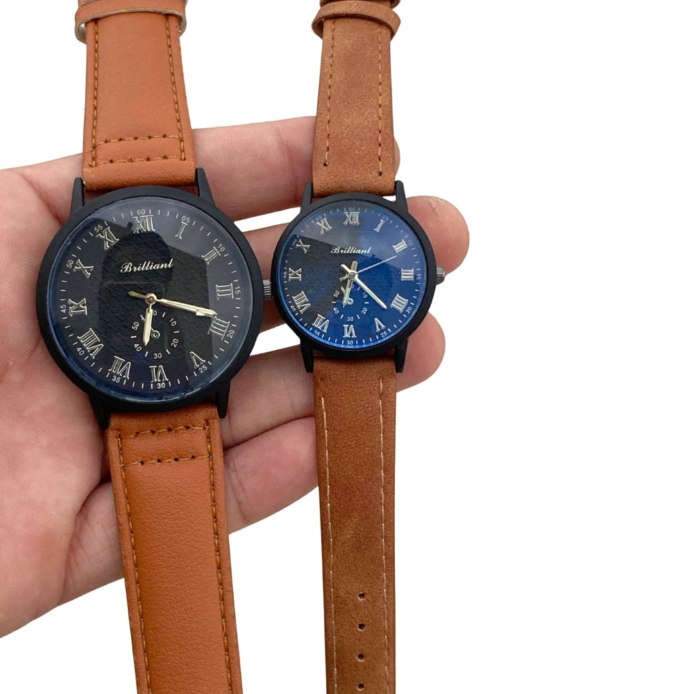 Two watches with brown leather straps held in a hand on a white background