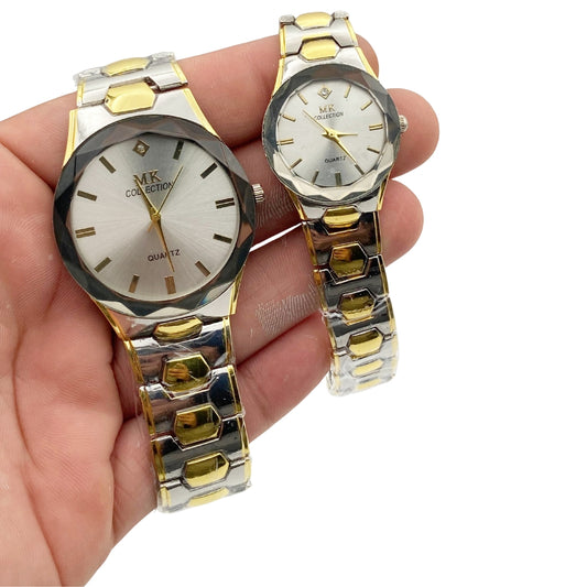 Two gold and silver watches held in a hand against a white background
