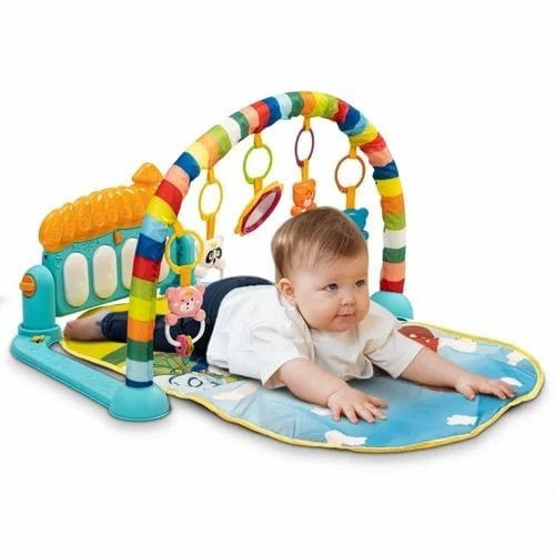 Baby lying on the play gym and engaging with toys