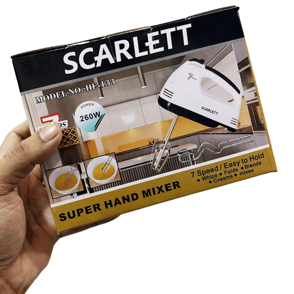 Hand holding a box of Scarlett super hand mixer with product image and text.
