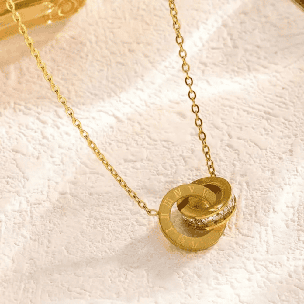 Close-up shot highlighting the details of the branded gold locket set