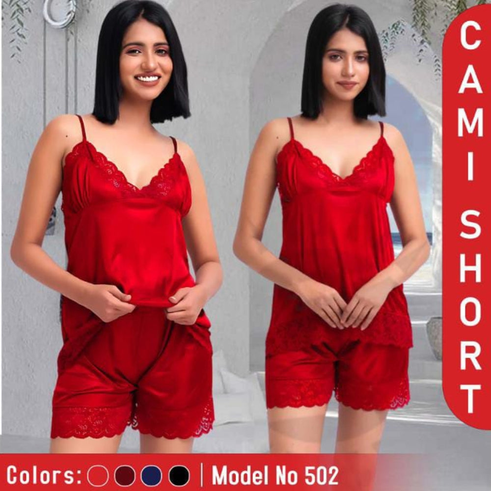 Woman wearing a red lace camisole and shorts set with a neutral background.