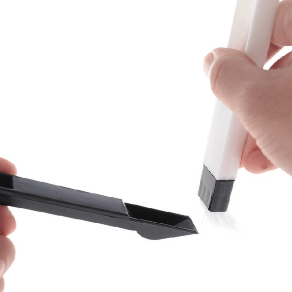 Cleaning brush held in hand, demonstrating pen-like grip