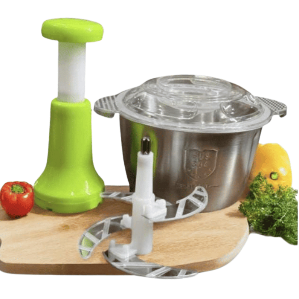 Kitchen appliance with green handle and metal base on a wooden cutting board with vegetables.