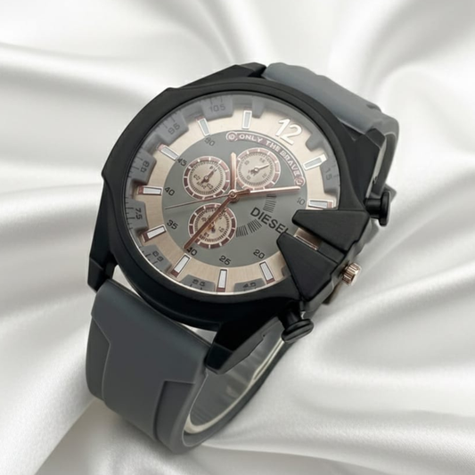Black and gray Diesel watch on a white fabric background