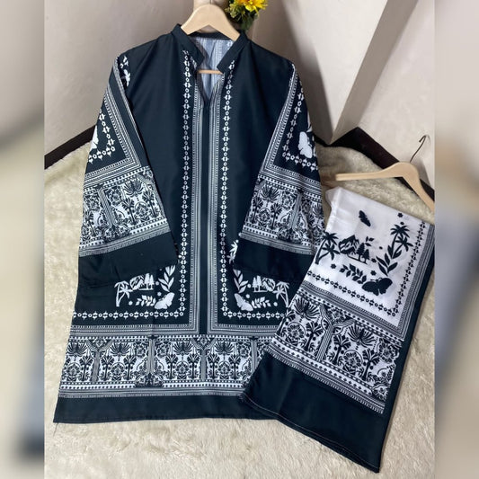 Black and white patterned garment on a hanger with a matching scarf on a textured surface.