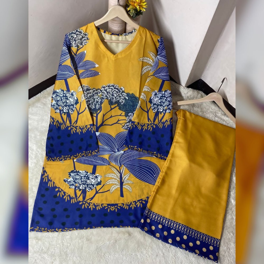 Yellow and blue patterned dress on a hanger against a white background