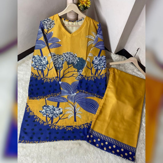 Yellow and blue patterned dress on a hanger against a white background