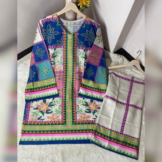 Colorful embroidered traditional outfit with a jacket and saree on hangers against a white background.
