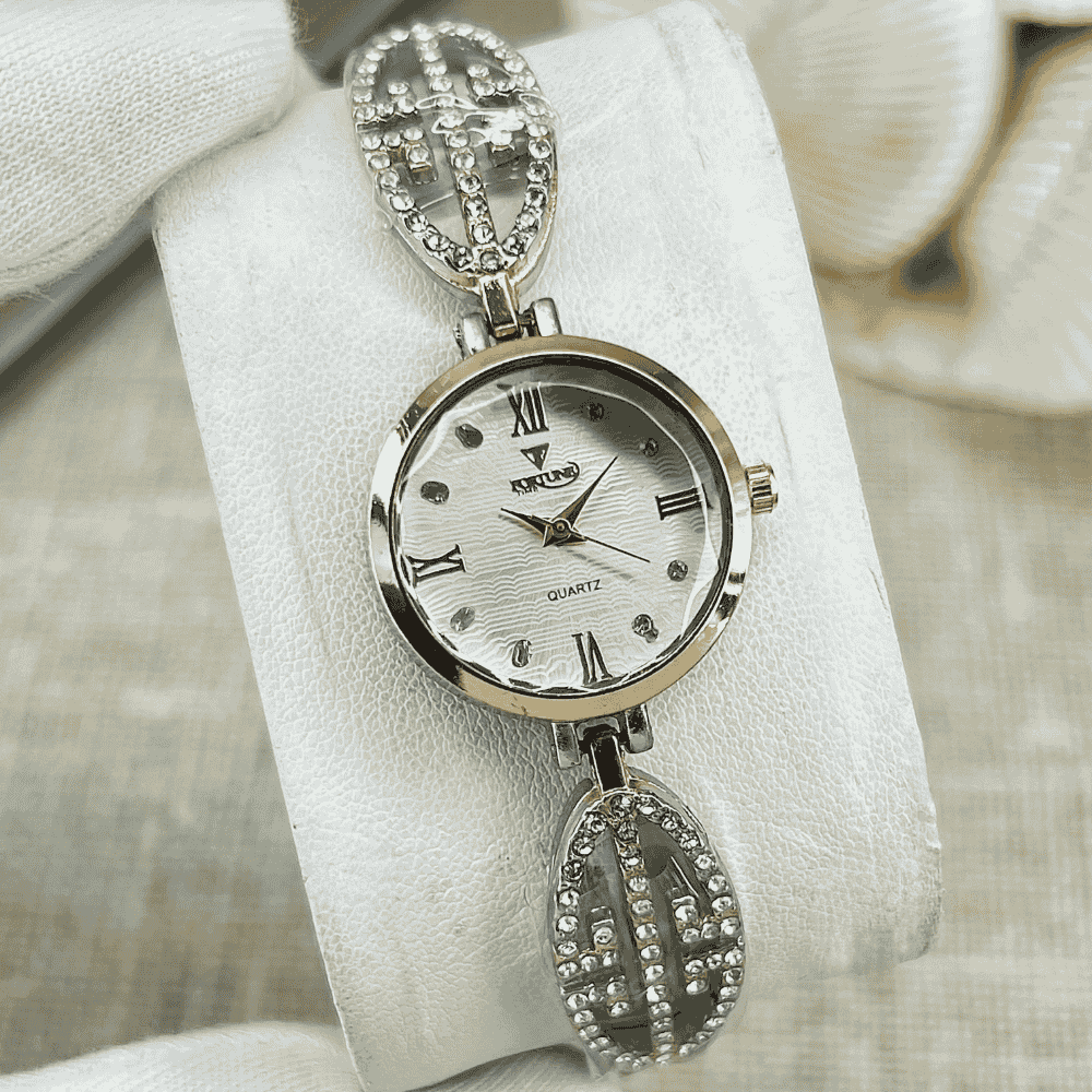 Silver wristwatch with decorative band on a white cushion