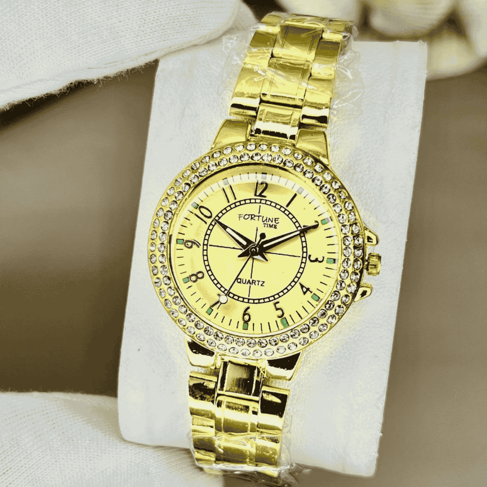 Gold wristwatch with diamond-studded bezel on a white cushion