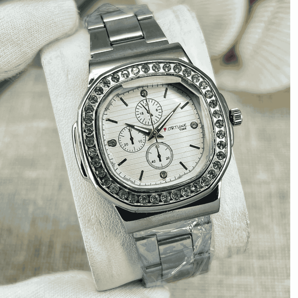 Silver watch with gemstone accents on a white cushion