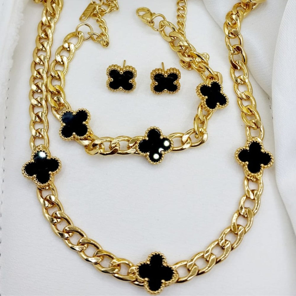 Gold necklace with black clover-shaped pendants on a white background