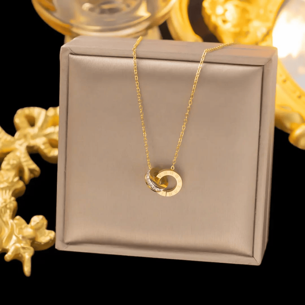 Front view of gold plated locket set presented inside a jewellery box