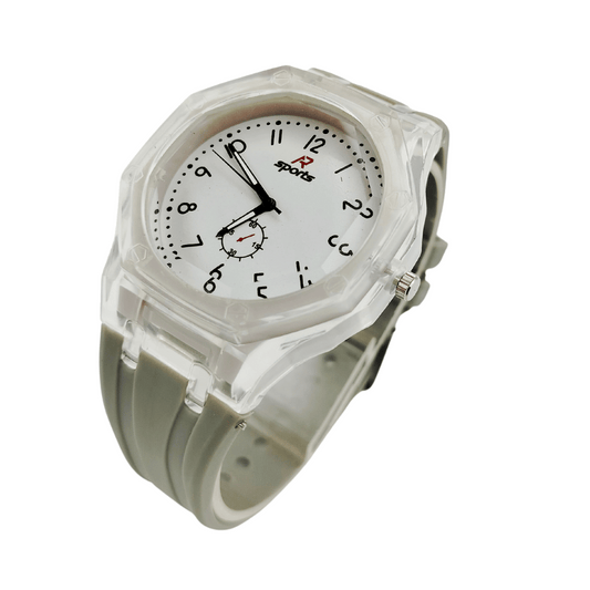 Child sitting at a desk wearing a sports watch with a gray rubber strap.