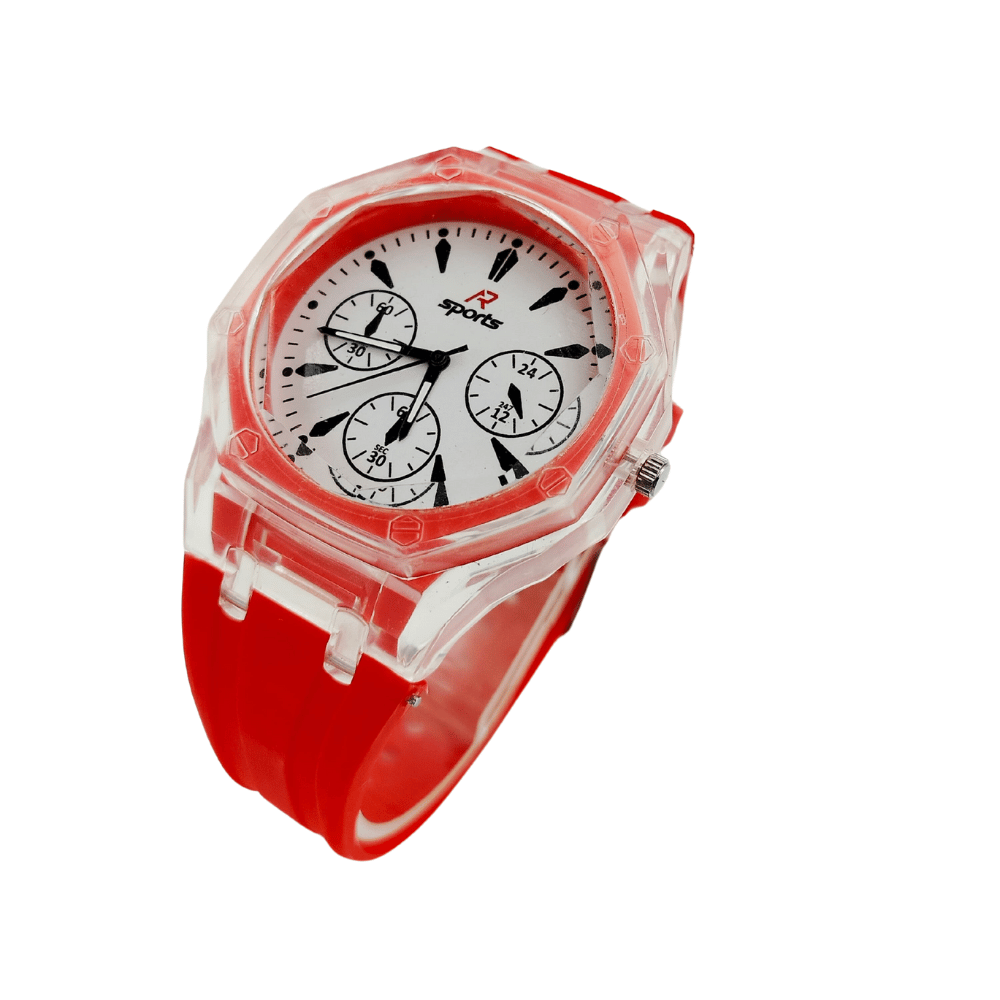 Child playing soccer wearing a sports watch with a red rubber strap.
