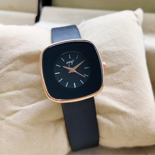 Wristwatch with black strap and rose gold case on a soft surface