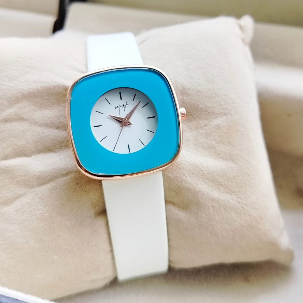 Watch with a blue face and white strap on a soft surface