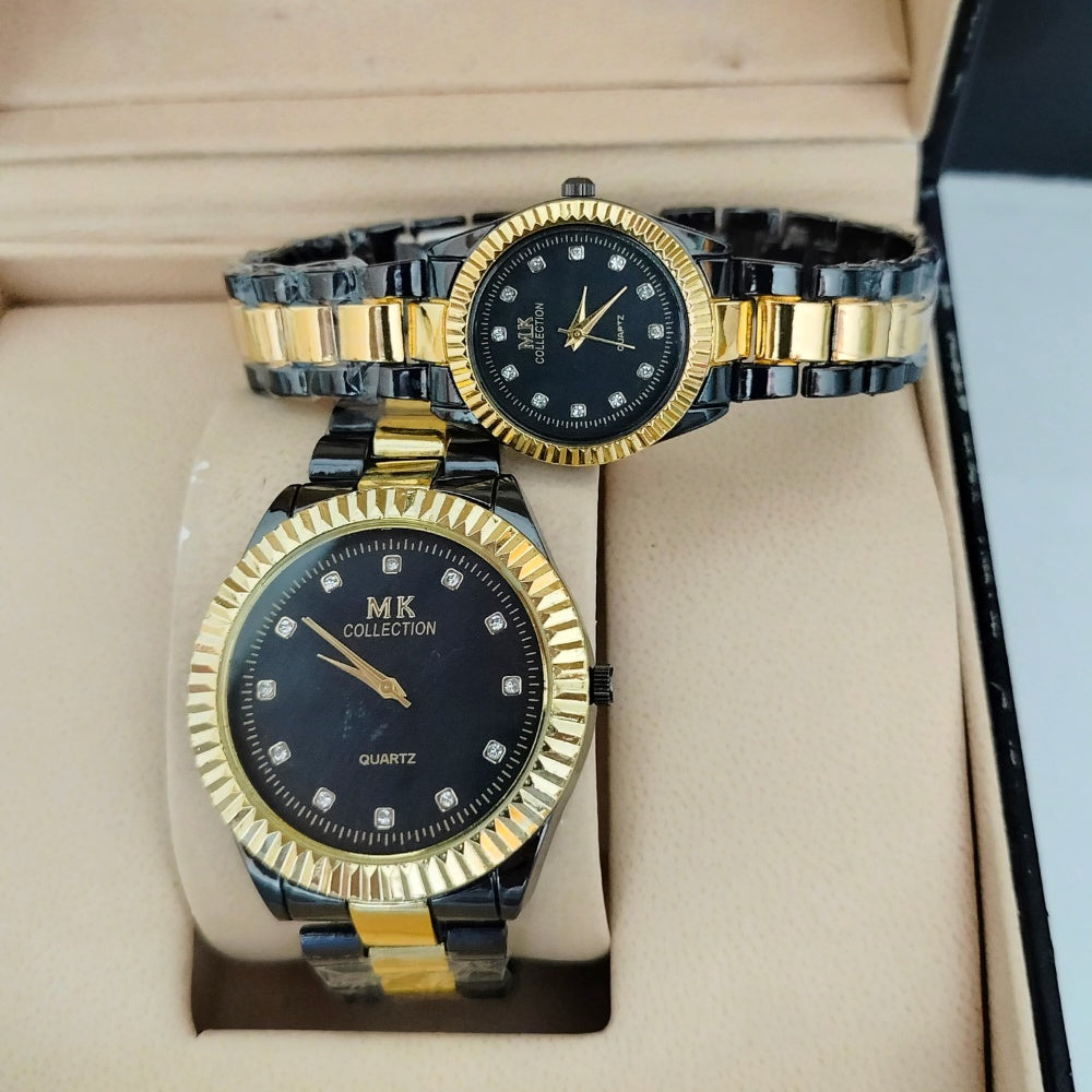 Two gold and black watches with diamond-studded faces on a beige cushion.
