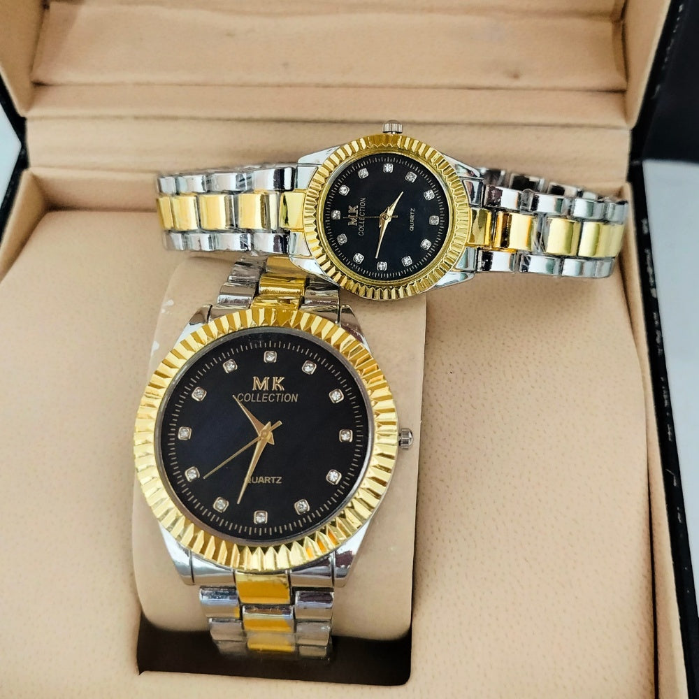 Two gold and silver watches with black faces in a box