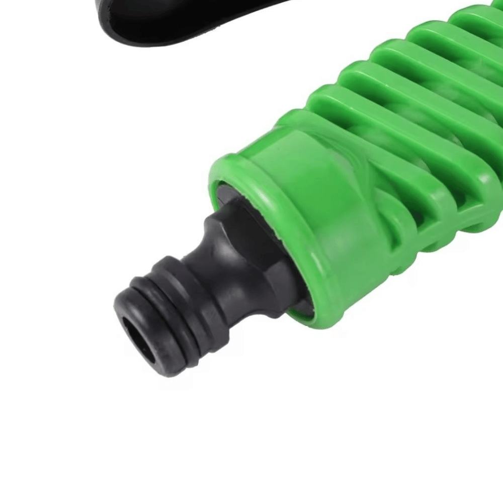 Green and black garden hose nozzle on a white background