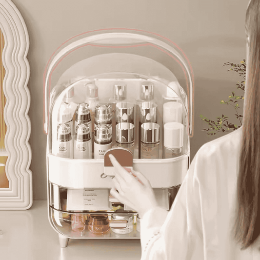 Person organizing skincare products in a transparent storage unit with a neutral background