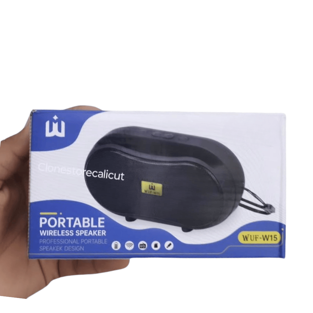 Hand holding a box of a portable wireless speaker with visible branding.