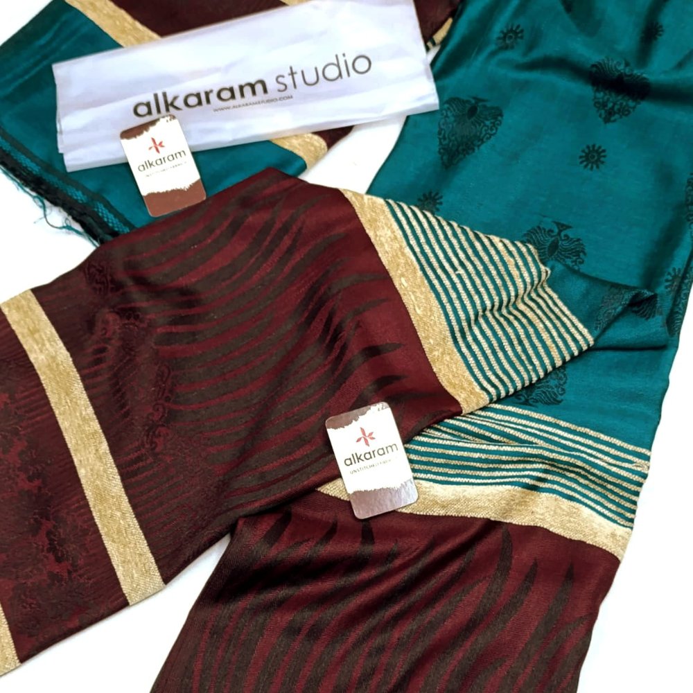 Saree with visible brand 'alkaram studio' on a white background