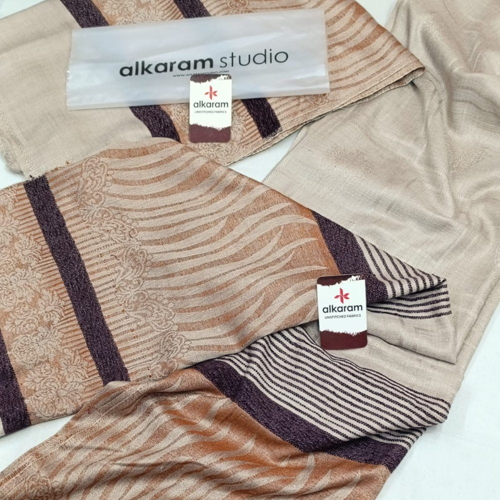 Textile with patterned design and 'alkaram studio' branding on a white background