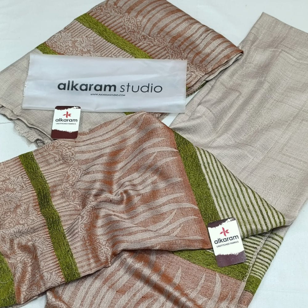 Textiles with 'alkaram studio' branding on a white background