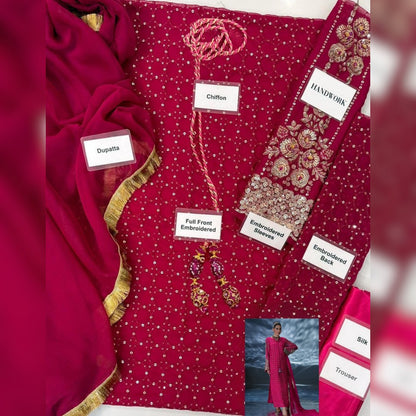 Red embroidered fabric with labels detailing its features, displayed on a white background.