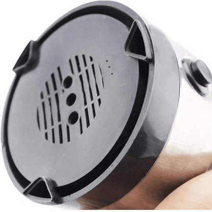 Metallic object with a textured surface held by a hand on a white background