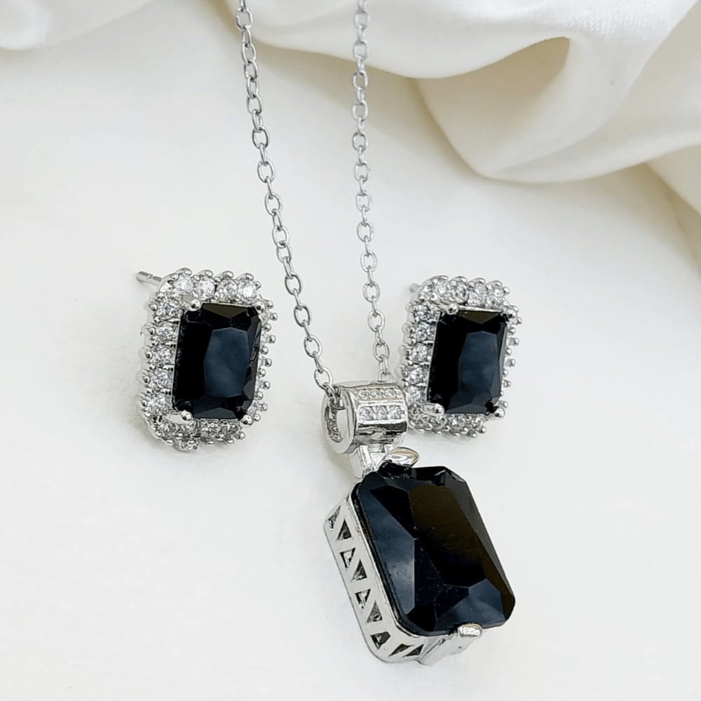 Front view of artificial black locket with matching earrings