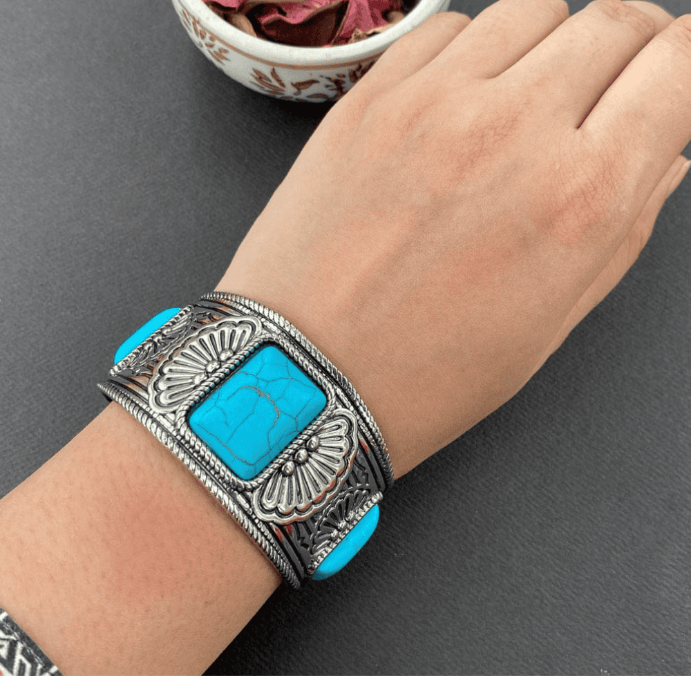 Blue antique bangle shown worn on hand from the top view

