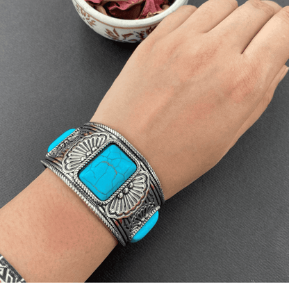 Blue antique bangle shown worn on hand from the top view
