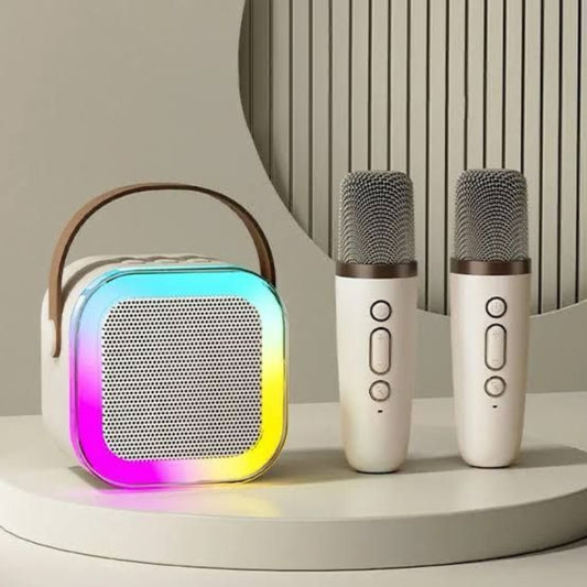 Portable speaker with colorful light effects and two microphones on a neutral background
