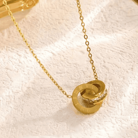 Close-up shot highlighting the details of the branded gold locket set

