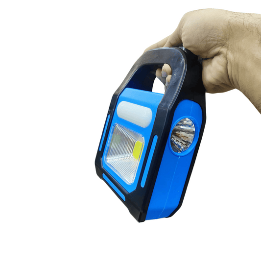 Hand holding a blue and black flashlight against a white background