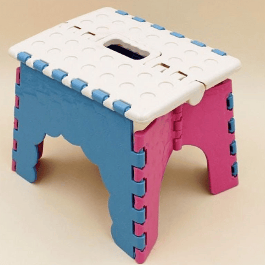 Foldable step stool with blue and pink design on a beige background