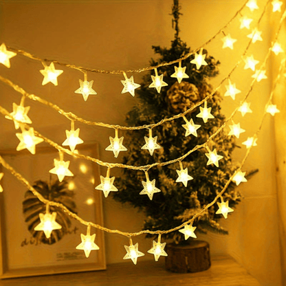 Star-shaped string lights hanging above a Christmas tree in a cozy room.