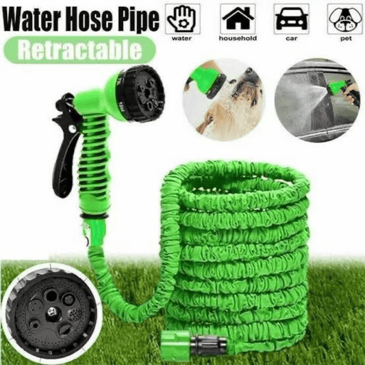 Retractable green water hose with spray nozzle on grass background