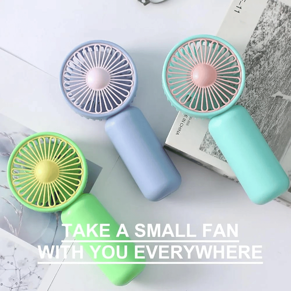 Three small handheld fans in different colors on a light surface with text 'Take a small fan with you everywhere'.