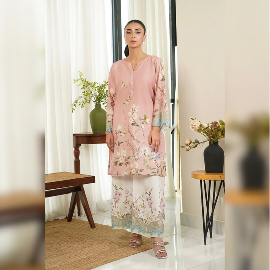 Woman in a floral dress standing in a room with decor elements.