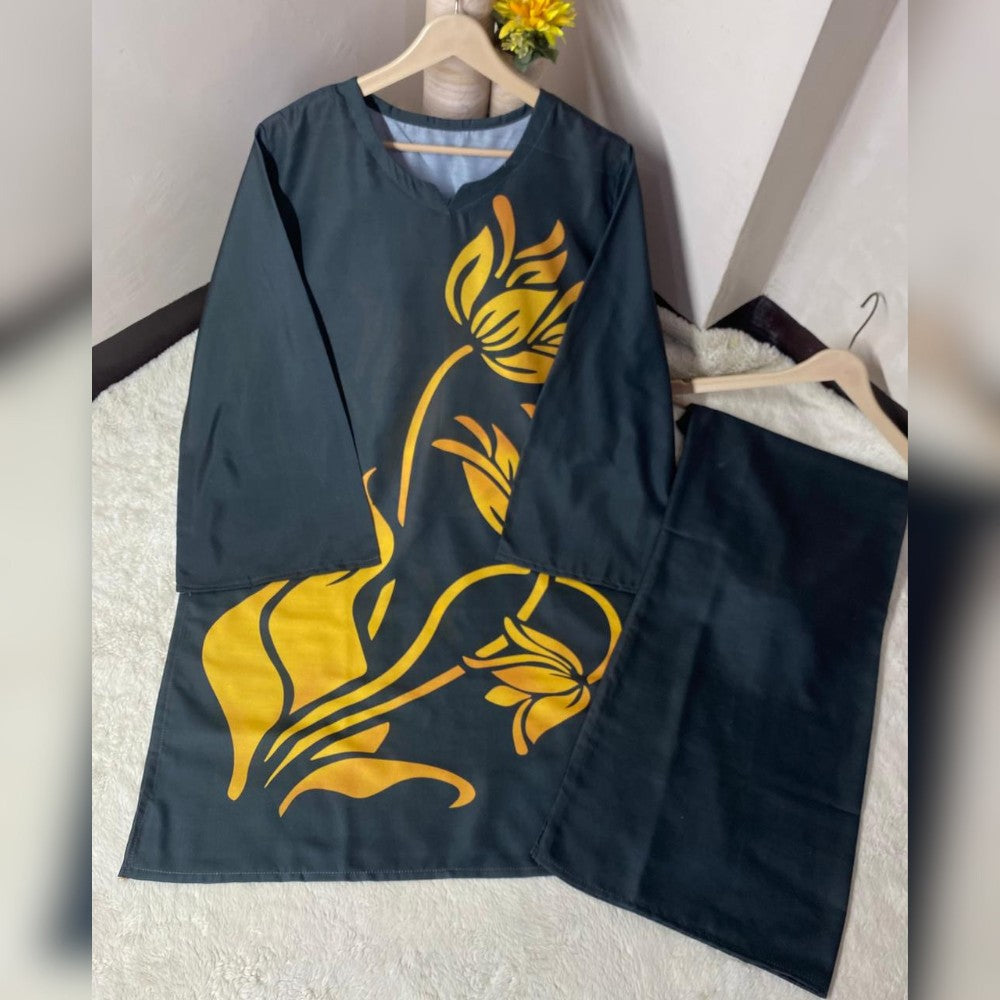 Black apron with yellow floral patterns on a white surface