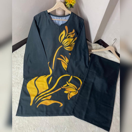 Black apron with yellow floral patterns on a white surface