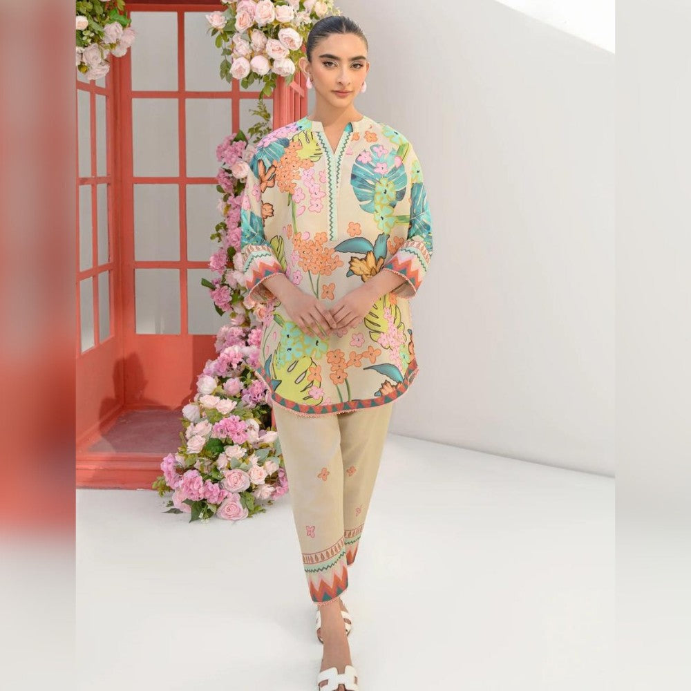 Woman wearing a colorful floral outfit with a white background and pink floral decorations.