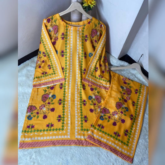 Yellow traditional outfit with floral patterns on a white surface